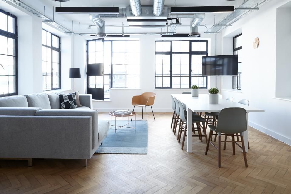 A meeting room with a long table and chairs