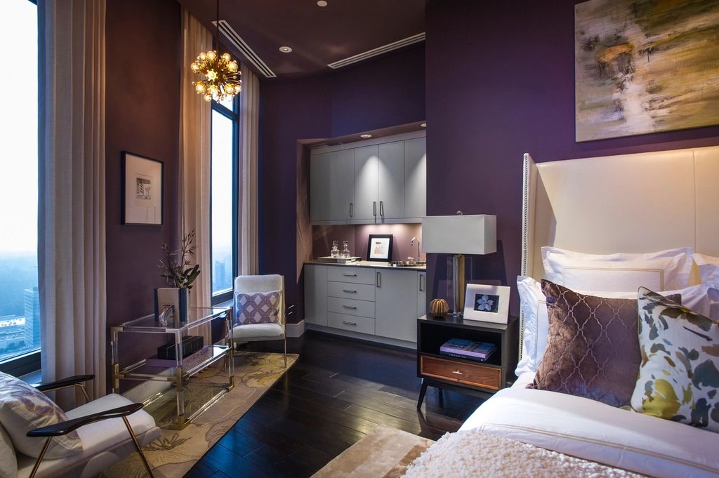 A guest room with a large bed and soft lighting